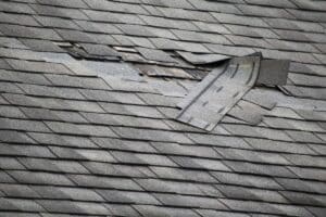 damaged roof with missing shingles