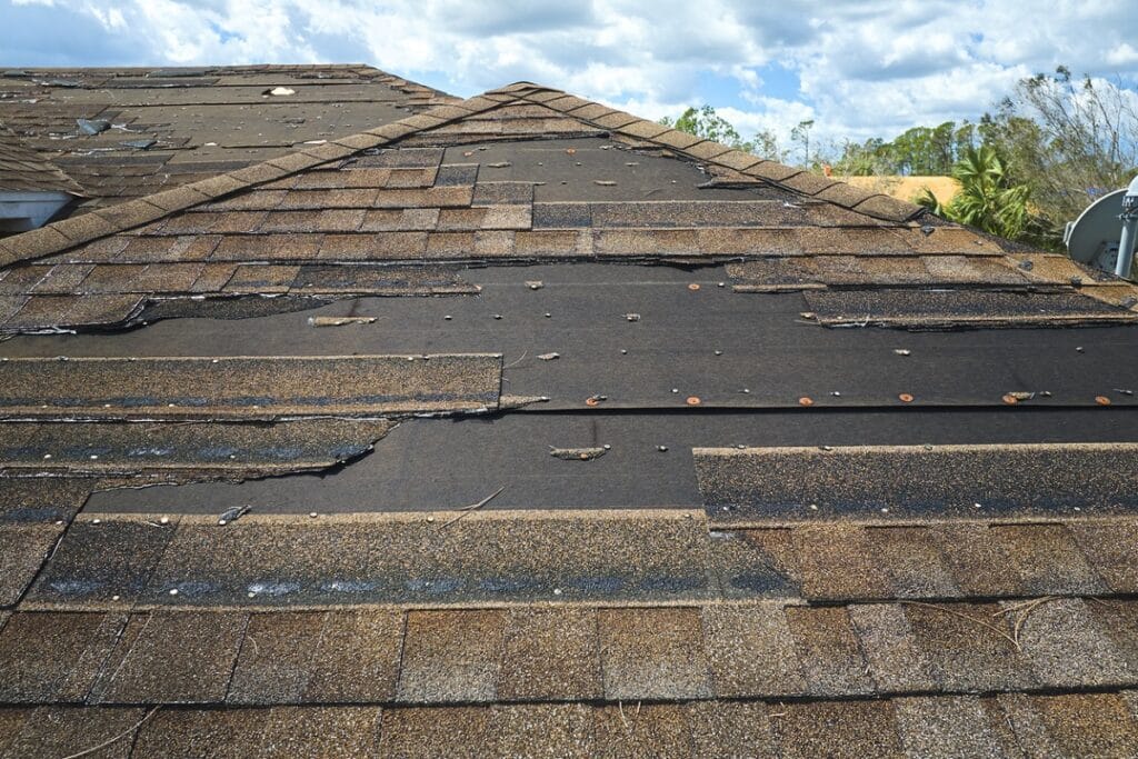 Damaged roof with missing shingles