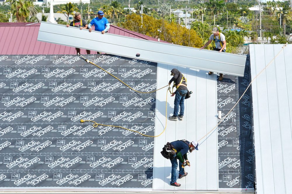 KEY WEST, FLORIDA, USA-JANUARY 31, 2019:  A roofing crew repairs damage to a tin roof caused by Hurricane Irma in Key West, Florida, on Thursday, January 31, 2019.